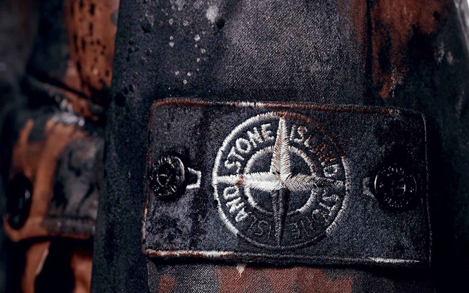 Stone Island Logo, text in the bottom and logo in the middle. Black on  white background.